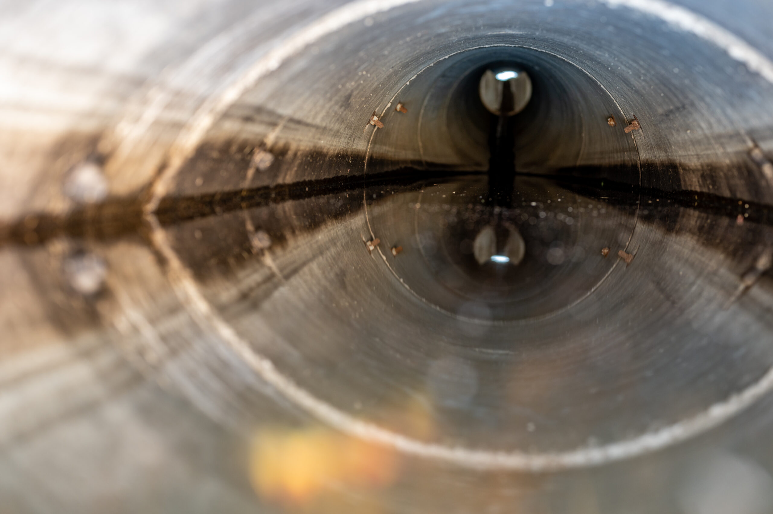 water surface level view from inside a concrete culvert